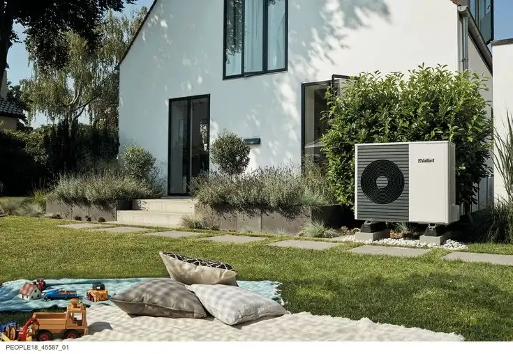 Modern air source heat pump next to a house